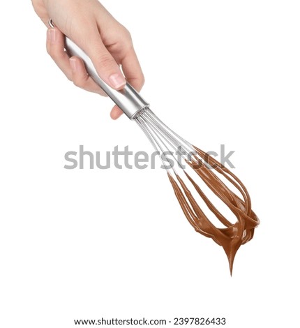 Woman holding whisk with chocolate cream isolated on white, closeup Royalty-Free Stock Photo #2397826433