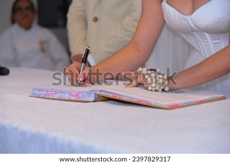 bride signing book, wedding signature book, marriage certificate, ceremony, certificate signing, religious wedding, catholic church
