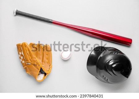 Baseball glove, bat, ball and batting helmet on light grey background, flat lay