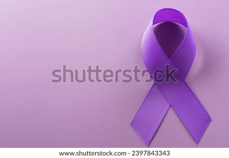 Purple ribbon on pastel paper background for supporting World Cancer Day campaign on February 4. Royalty-Free Stock Photo #2397843343