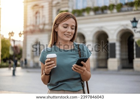 Shot of a young businesswoman using a cellphone in the city.