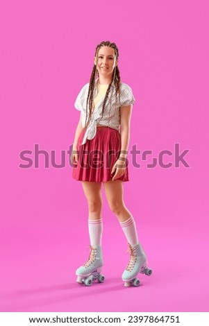 Young woman with dreadlocks and roller skates on pink background Royalty-Free Stock Photo #2397864751