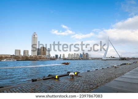 nieuwe maas river and erasmus bridge seen from waterfront of kop van zuid in dutch city of rotterdam on sunny day with blue sky Royalty-Free Stock Photo #2397867083
