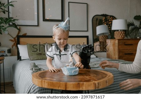 Boy blowing out a candle on a birthday cake.