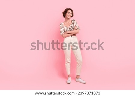 Full length photo of good mood cheerful cute woman wear print top white pants holding arms crossed isolated on pink color background