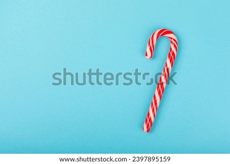 Candy cane.Christmas candy canes on a blue background. Holiday greeting card. Concept for Christmas and New Year holidays. Winter. Flatlay, top view, copy space.