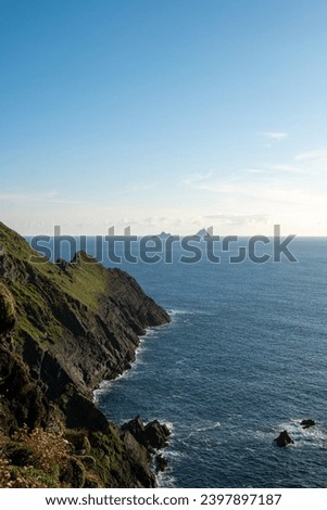 View of Kerry Cliffs coast and Skellig islands in the background at sunset, Ireland Royalty-Free Stock Photo #2397897187