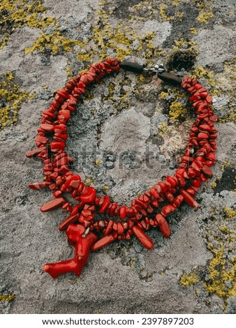 Red wide coral necklace Ukrainian traditional jewelry Red triple necklace with pendant at natural rock granite stone Irregular beaded jewellery, female accessory Culture of Ukraine Fashion accessory Royalty-Free Stock Photo #2397897203