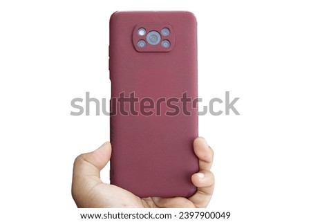 man's hand holding a cellphone with a pink case. isolated on white background