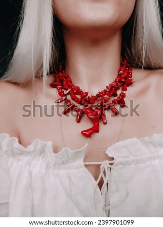 Red wide coral necklace Ukrainian traditional jewelry style Red triple necklace with pendant at woman's neck Irregular beaded jewellery, female accessory Culture of Ukraine Fashion accessory Model Royalty-Free Stock Photo #2397901099