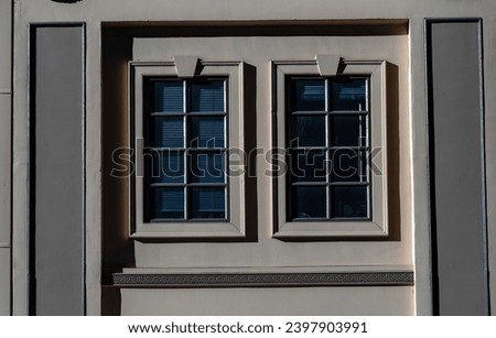 Charcoal and Tan Building Wall with Twin Picture Windows.