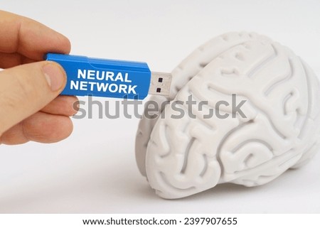 A man inserts a flash drive into his brain with the inscription - Neural Network. Education and technology concept. Royalty-Free Stock Photo #2397907655