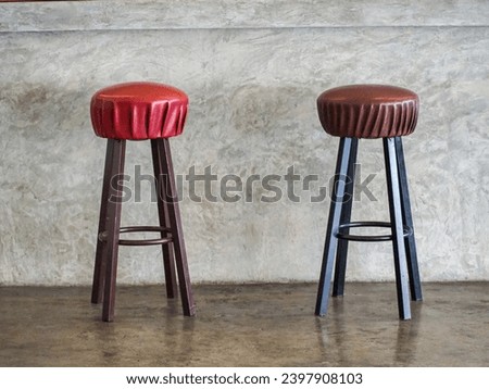 A bar stool is a tall stool with a footrest for use at a bar or counter.