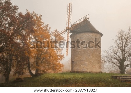 Mist surrounds the Moulin de Domme, an ancient windmill in the village of Domme in the Dordogne region of France Royalty-Free Stock Photo #2397913827