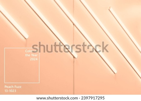 Abstract light lamps on the wall toned in trendy pantone Peach Fuzz color of Year 2024