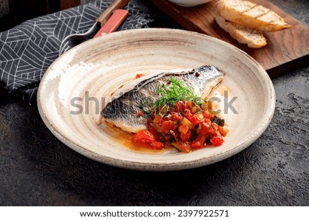 Fillet of White sea bass fish with stewed vegetables served with stewed vegetables on a plate Royalty-Free Stock Photo #2397922571