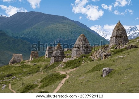 Ancient burial complex in the vicinity of the mountain village of El'tiubiu on a sunny June day. Kabardino-Balkaria, Russia Royalty-Free Stock Photo #2397929113