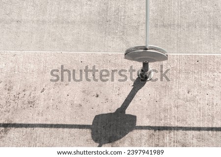 glancing down at metal bracket system securing thick glass panels Royalty-Free Stock Photo #2397941989