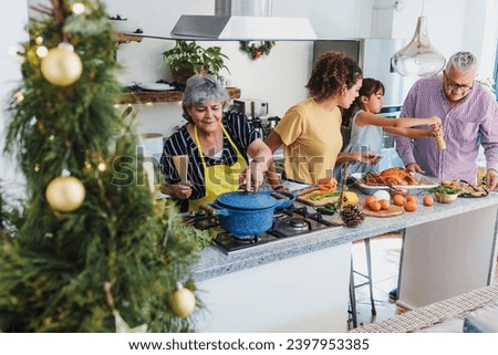 Latin family cooking together for Christmas dinner at home in Mexico Latin America, hispanic people mother, grandparents and daughter preparing turkey meat in holidays
