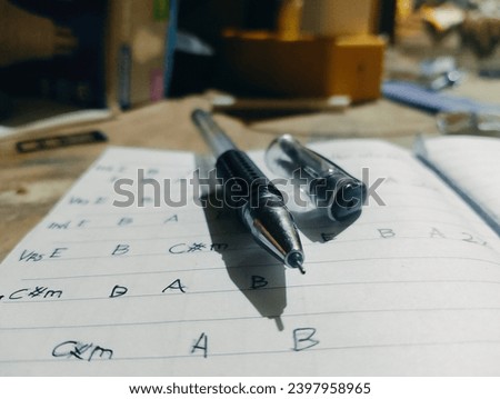 photo of a collection of chords arranged and written with ink pen to form a harmonious song Royalty-Free Stock Photo #2397958965