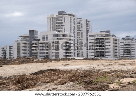 new construction Development, in Israel, buildings. Building new apartments on a construction site with heaps of ground in front. 