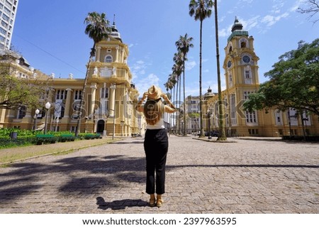 Tourism in Porto Alegre, Brazil. Back view of young tourist woman visiting the historic center of Porto Alegre, Rio Grande do Sul, Brazil. Royalty-Free Stock Photo #2397963595