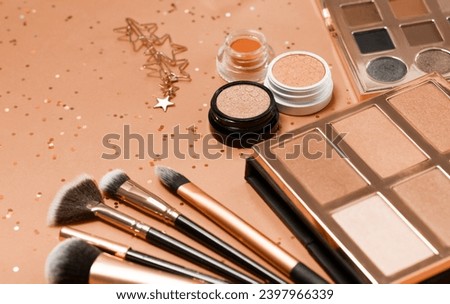 Flat lay of Makeup cosmetic product on pink background. New trending PANTONE 13-1023 Peach Fuzz colour of 2024 year 