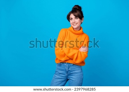 Photo of funky dreamy lady wear knitted pullover arms folded looking empty space isolated blue color background