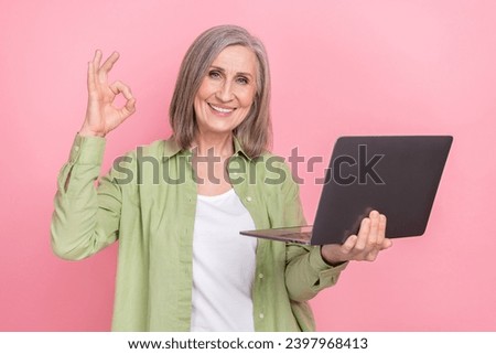 Photo of grandmother buy new modern laptop light weight fast speed processor advertisement okey symbol isolated on pink color background