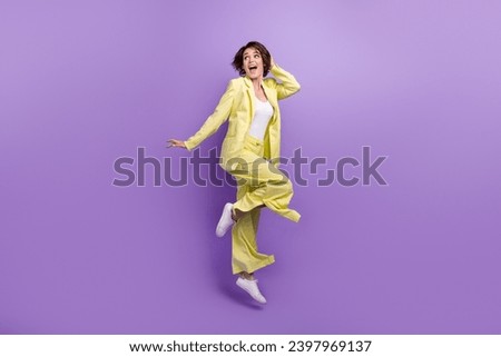 Full length photo of optimistic woman dance jump overjoyed lime style garment funny person good vibe isolated on purple color background Royalty-Free Stock Photo #2397969137