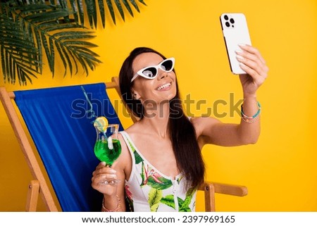 Photo of pretty adorable lady wear swimsuit recording video vlogging gadget relaxing lounge chair isolated yellow color background