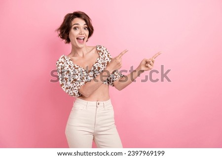 Portrait of cheerful impressed person direct fingers empty space offer ad blank isolated on pink color background