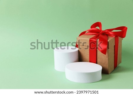 Bright gift near a white podium with copy space