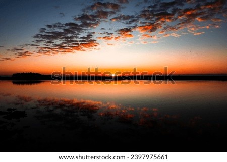 These photos depict sunrise and sunset over the marsh and water in Lowcountry Charleston South Carolina. The exact location is Buck Hall Recreational center and Boat Ramp Royalty-Free Stock Photo #2397975661
