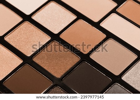 Palette of colorful eyeshadows from high view. New trending PANTONE 13-1023 Peach Fuzz colour of 2024 year 