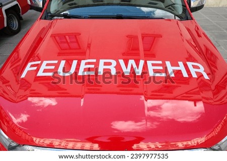 Red fire truck. Sign firefighter on a car. Inscription: Feuerwehr.  