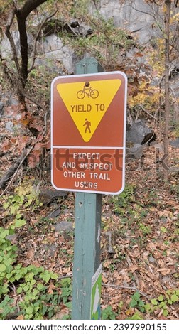 biking hiking trail brown yellow yield sign