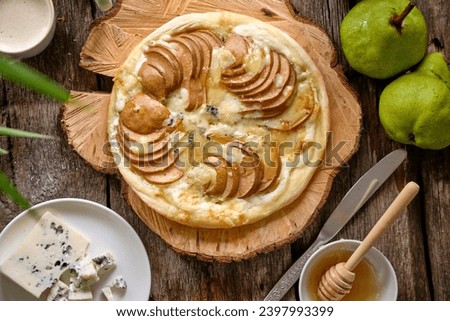 Flatbread Pizza with pear Gorgonzola and honey Royalty-Free Stock Photo #2397993399