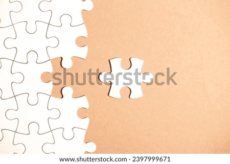 White puzzle with missing part on beige background. Business concept. Demonstrating color of 2024 year - peach.