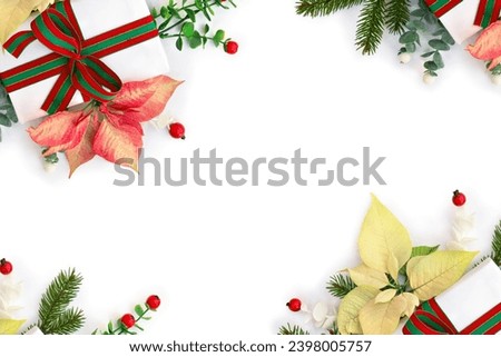 Christmas decoration. Gift box, red and white yellow poinsettia flowers, Christmas tree branch, red berries on a white background with space for text. Top view, flat lay