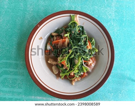 Stir-fried kale or sometimes called  cah kangkung is a stir-fried vegetable dish where kale is stir-fried with a mixture of various vegetables, spices and chicken. 