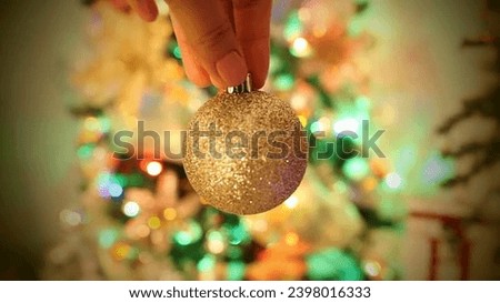 Merry Christmas and Happy New Year. close up of woman hand holding christmas ball. 



