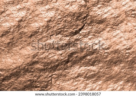 Fragment of a wall from a chipped stone. New trending PANTONE 13-1023 Peach Fuzz colour of 2024 year 