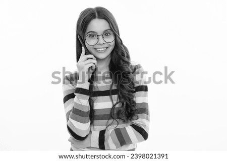 Happy smiling girl 12, 13, 14 years old with smart phone. Hipster teen girl types message on cellphone, enjoys mobile app. Kid hold smartphone texting in online social media. Internet addiction.