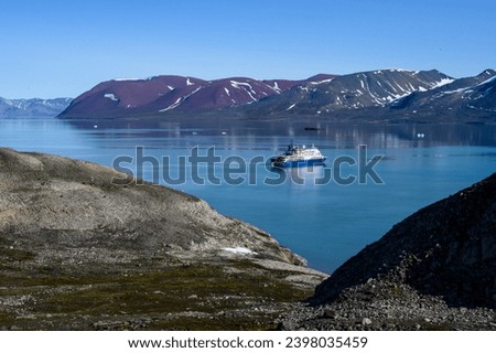 Arctic cruise ship in Liefde Fjord, Svalbard, expedition tourism in the high arctic viewed from a mountain top
 Royalty-Free Stock Photo #2398035459