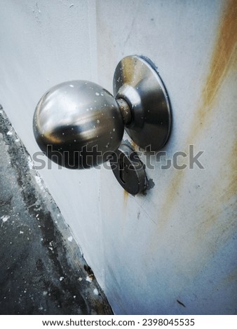 Broken modern doorknob closeup with signs of forced entry, criminal activity and door slightly open. Breaking and entering concept