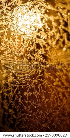A golden frosted glass with a warm light behind