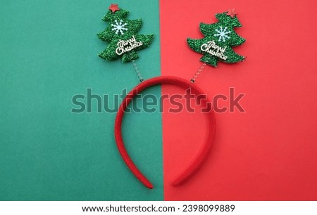 decorated Beautiful headband funny christmas trees t isolate on a green and red backdrop.
concept of joyful Christmas party,New year is coming soon, festive season decoration with Christmas elements