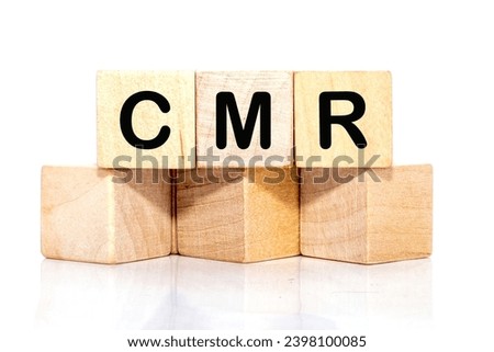 CMR Contract Management Review or Clear Motion Rate inscription on wooden cubes on a white background