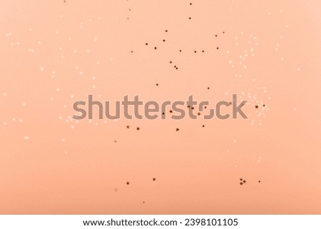 Trendy pink background with gold sequins and stars.